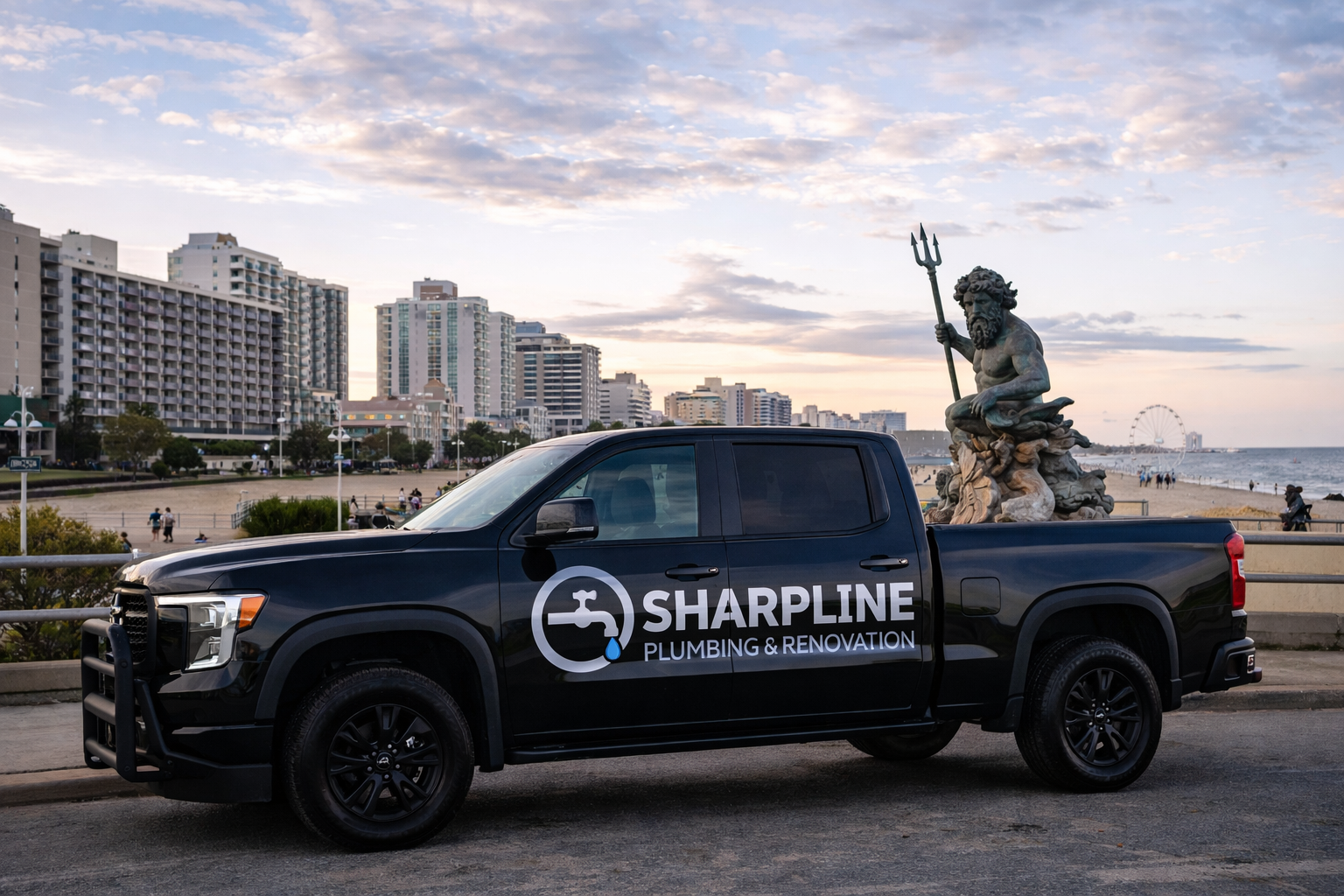 Black Sharpline Plumbing & Renovation pickup truck parked at Virginia Beach Oceanfront near King Neptune statue, representing service across Virginia’s 7 Cities.